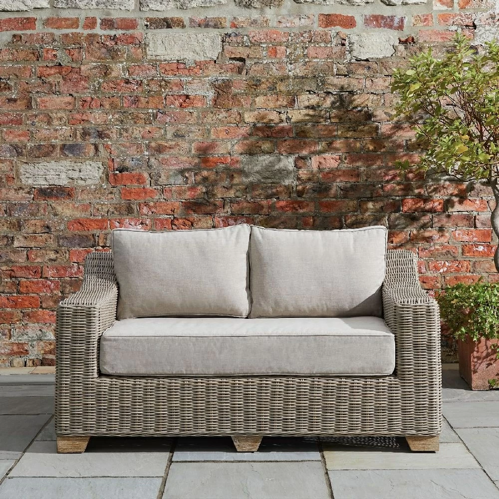 Capri Collection Outdoor Furniture Beige Rattan Two Seater Sofa Shower Resistant Cushions